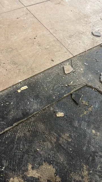 Black bitumen mastic floor removal in a W7 flat